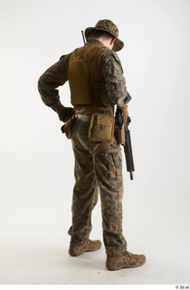 Casey Schneider in WDL Marpat Pose 5 loading gun standing…